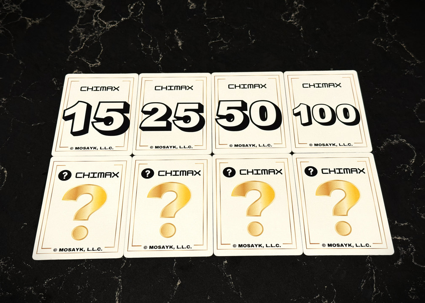Set of Chimax card game cards with question marks and numbers on a dark surface