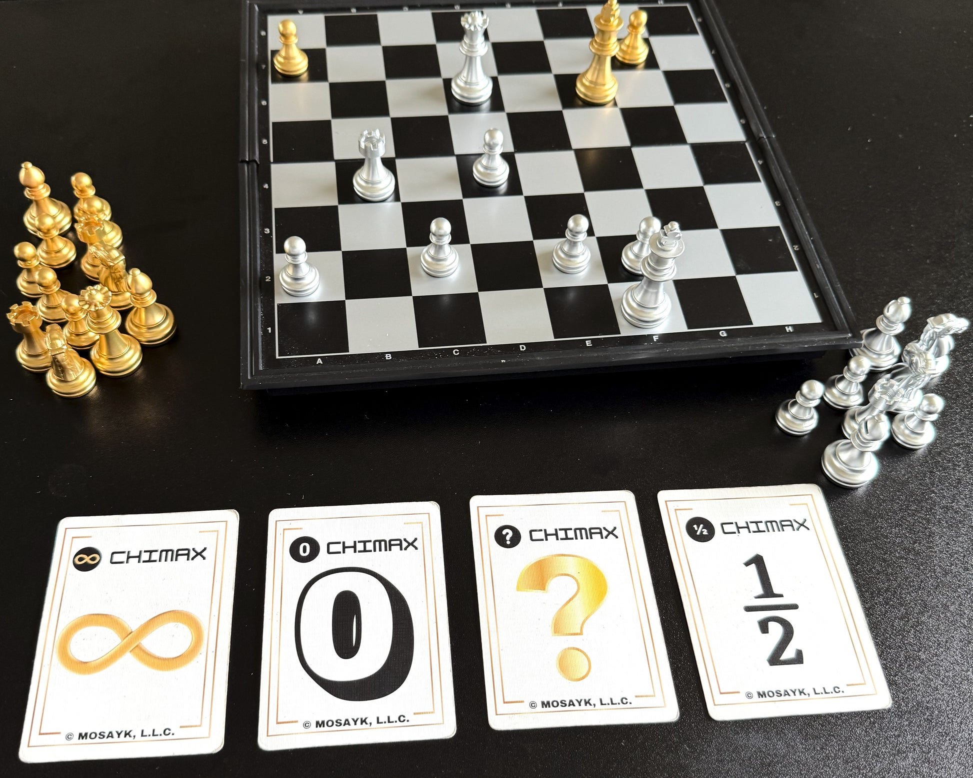 Chessboard with chess pieces and Chimax branded cards on a black surface