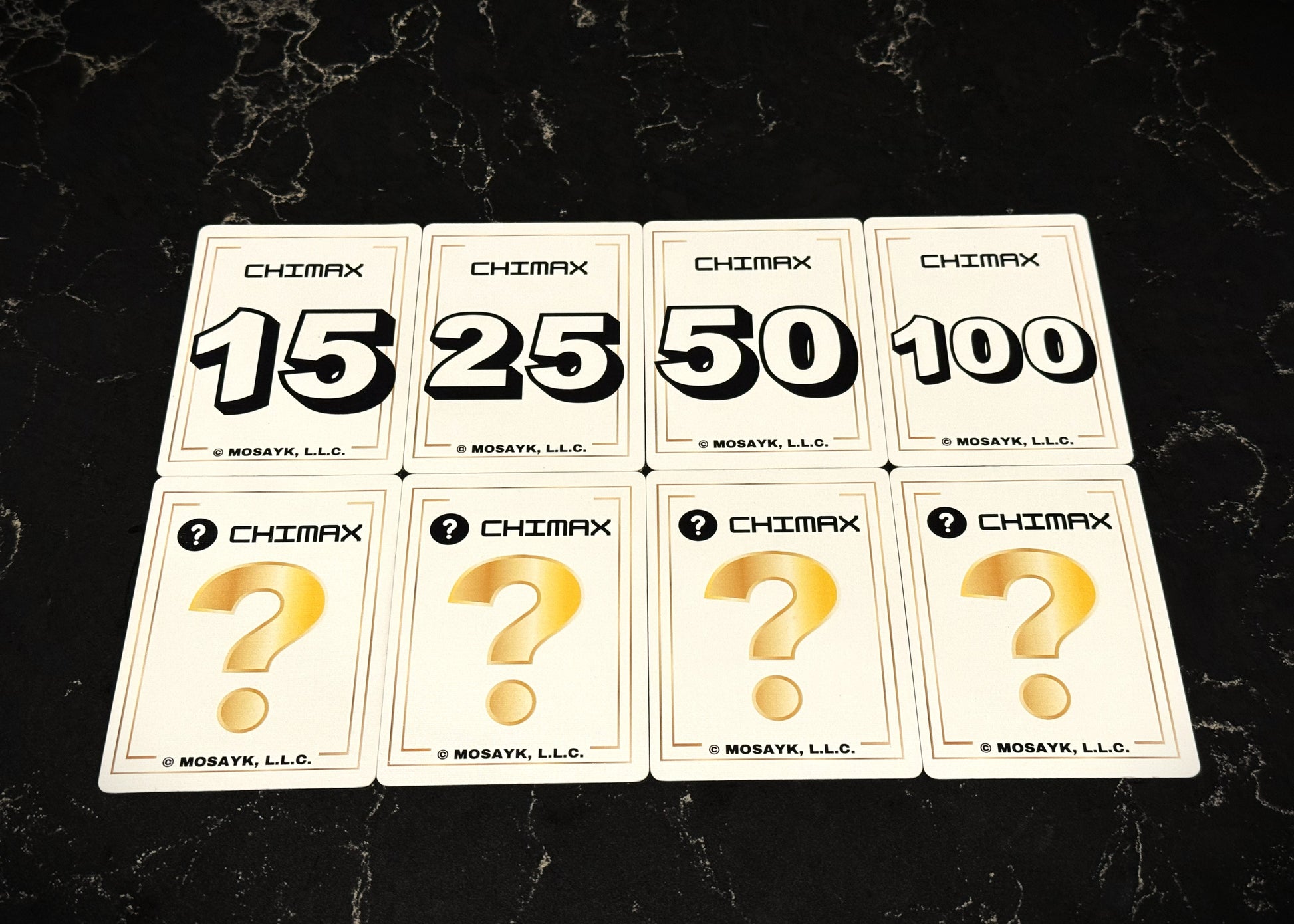 Set of Chimax card game cards with question marks and numbers on a dark surface